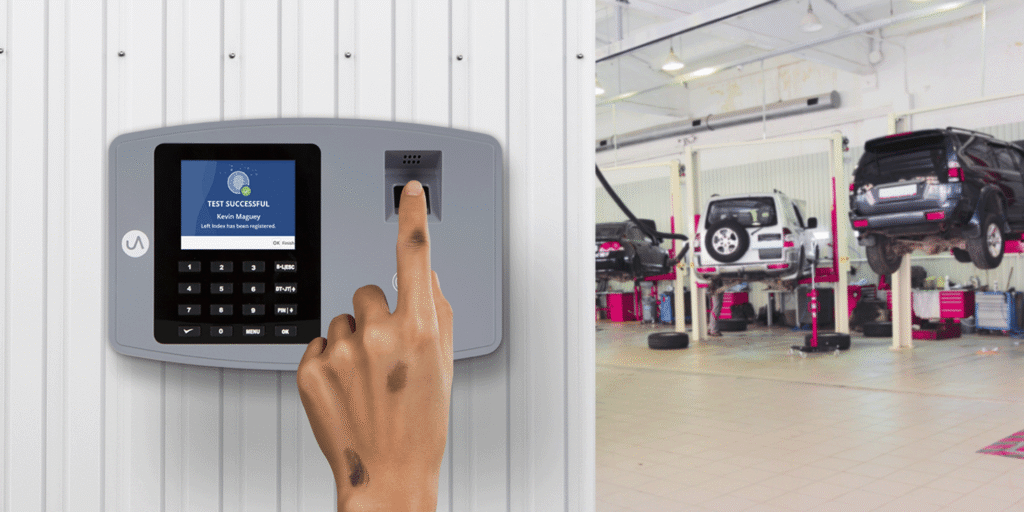 Employee clocking in with a fingerprint biometric time clock at an auto body shop