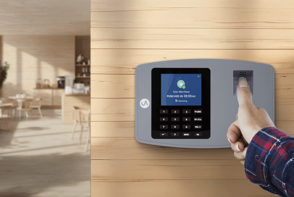 Employee using a fingerprint time clock to verify identity and prevent buddy punching