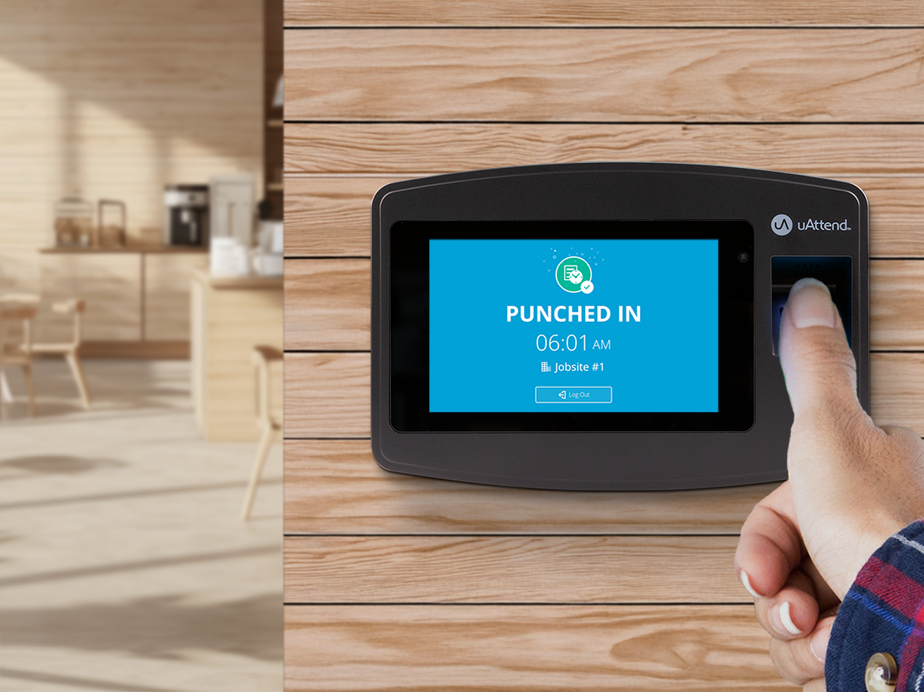 Employee placing a thumb on a biometric time clock for fingerprint punch-in